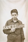 Eugenius Kamer holds a name card intended to help any of his surviving family members locate him at the Kloster Indersdorf DP camp.