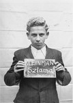 Szlama Kleinman holds a name card intended to help any of his surviving family members locate him at the Kloster Indersdorf DP camp.