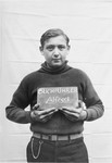 Alfred Buchfuhrer holds a name card intended to help any of his surviving family members locate him at the Kloster Indersdorf DP camp.