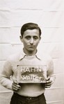 Walter Hahn holds a name card intended to help any of his surviving family members locate him at the Kloster Indersdorf DP camp.
