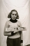 Nina Krieger holds a name card intended to help any of her surviving family members locate her at the Kloster Indersdorf DP camp.