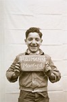 Manfred Hajmann holds a name card intended to help any of his surviving family members locate him at the Kloster Indersdorf DP camp.