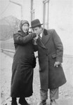 Baruch Nieman kisses the hand of his mother Etta Nieman on a street in Viseul-de-Mijloc, Transylvania.