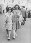 A Jewish mother and daughter walk along a street in Bucharest near the end of the war.