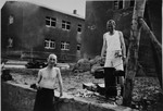 Two Buchnewald survivors in Buchenwald prepare a meal after liberation.
