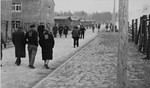 Survivors walk though a path in Buchenwald after liberation.