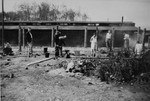Survivors in Buchenwald preparing their noon meal after liberation.