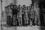 Group portrait of child survivors of Buchenwald.  

The young boy in the middle is Joseph Schleifstein.