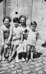 Four children pose outside on a summer day.

Pictured is Rudolf Cohen Jacobsohn (right) with his cousins Inge and Howard Spicker and a neighbor.