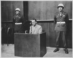 Flanked by two military policemen, Hermann Goering testifies at the International Military Tribunal trial of war criminals at Nuremberg.