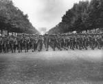 American troops with the 28th Infantry Division march in formation down the Champs-Elysees in Paris during a victory parade.