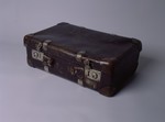Small brown leather suitcase with metal clasps and corner reinforcements that was carried by the Leikachs, a family of Jewish survivors, from Poland to Italy.