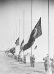 German soldiers raise the flags of nations participating in the 11th Olympiad.