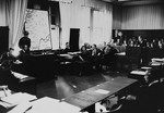 Defendant Dr. Otto Ohlendorf (right) gives testimony in a smaller courtroom in the Palace of Justice during the Einsatzgruppen Trial.