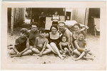 A prosperous Jewish family poses in front of a beach cabana while on vacation in Lido.