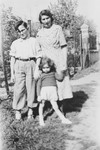 Rene Lichtman poses in a garden with his Helene and older cousin.