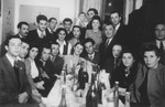 A group of friends celebrates the wedding of  Jacob and Miriam Schwimmer in the Bari dispaced persons camp.