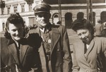Felicja Berland and a friend pose with a Jewish soldier in the Polish Army on a street in Lodz.