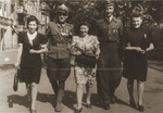 Felicja Berland (center) and two girlfriends walk along a street in Lodz with two Jewish lieutenants in the Polish Army.