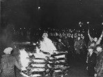 SA members and university students march in a torchlight  procession around the bonfire of "un-German" books on the Opernplatz.