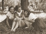 Three Jewish girlfriends in a park in Chelm.  

Pictured from left to right are: Genia Karpenkopf, Felicja Berland, and Hanka Aljos.