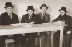 Four Jews study religious texts at a yeshiva in the Stuttgart DP camp.