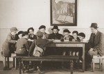 A rabbi teaches a group of boys in a cheder [religious elementary school] in the Stuttgart DP camp.