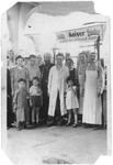 German Jewish refugees pose with local residents in Siegfried Kaiser's butcher shop in Shanghai.