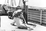 Werner Lenneberg (left) and Fritz Buff (right) play shuffleboard on the deck of the MS St.