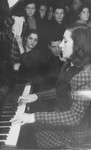 A young woman plays the piano during a Hanukkah celebration in the Zeilsheim displaced persons' camp.
