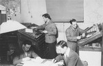 The staff of the DP newspaper, Unterwegs [The Transient], at work in their office in the Zeilsheim displaced persons' camp.
