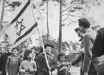 Jewish children at the Foehrenwald DP camp line up while NCWC distributes recreational and educational supplies to the camp members.