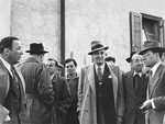 Saul Sorrin (with his back to the camera) director of UNRRA in the Munich area, and Samuel Haber (right) director of the JDC in Germany, converse with American Jews who are on an official visit to the Foehrenwald displaced persons camp.
