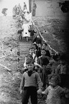 Jewish preschoolers walk down a flight of stairs at the Bergen-Belsen displaced persons camp.