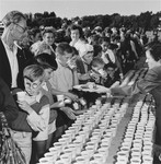 Newly arrived refugees receive food and drink at a picnic at Fort Ontario in Oswego, New York.