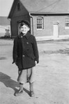 12-year-old Zigmund Krauthamer poses in front of a barracks at the Fort Ontario emergency refugee shelter.