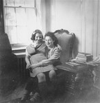 Two Jewish sisters who survived the war hiding in France, pose in their room shortly after their arrival in the United States.