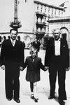 Guta Tyrangiel poses in the street with her uncle, Meyer Tyrangiel, and her rescuer and adopted father, Josef Jaszczuk.