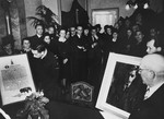 At a postwar ceremony in Holland, Jews who were rescued by Arie van Mansum during the German occupation, present him with a portrait and a certificate listing the names of those he saved.