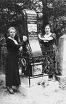 Lisa Abramowitz Shapiro and her sister Genia Abramowitz Sokobinson pose by the grave of their mother, Chaye Resha Abramowitz..