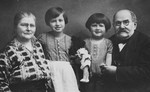 Portrait of the Loeffler family.

From left to right are Marie Loeffler, her grandaughters Mitzi and Susanna, and Ignatz Loeffler.