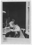 Ursula Klipstein does homework at a desk in her room.