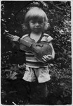 Portrait of a young Jewish child holding a violin in Bilki.