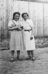 Two Jewish sisters pose outside during a visit to their grandparents' home in Pruchnik, Poland.