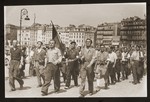 A group of Jewish men, members of the emigre section of F.T.P.F.( Franc Tireurs et Partisans Francais), a communist dominated resistance organization, march during a liberation celebration.