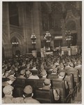 Chaplain Judah Nadich delivers a sermon to American servicemen at a Thanksgiving service in the rue de la Victoire synagogue in Paris.