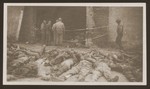 American soldiers look at the charred bodies of prisoners burned alive by the SS in a barn outside of Gardelegen.