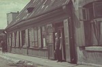 A barber stands outside his shop in the Lodz ghetto.