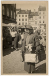 Close-up portrait of a Jewish woman shopping in an open-air market in prewar Lvov.