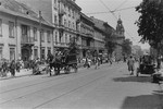 A horse-drawn funeral hearse drives along Leszno Street in the Warsaw ghetto.